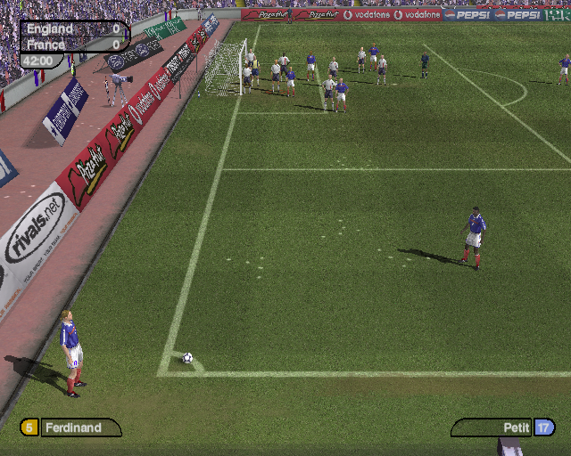 World Tour Soccer 2002 (PlayStation 2) screenshot: It's a French corner. The stadium advertising shows up well doesn't it, better that Ferdinand who's the current active England player Demo version