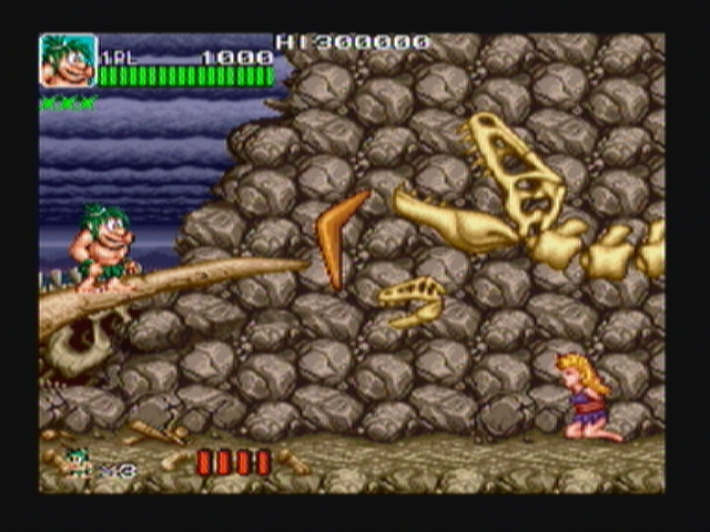 Joe & Mac: Caveman Ninja (Zeebo) screenshot: The boss here is a dinosaur skeleton.