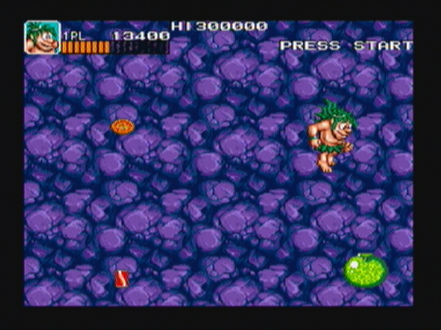 Joe & Mac: Caveman Ninja (Zeebo) screenshot: After beating the euoplocephalus, the ground will crumble and Joe will fall to a short vertical scrolling bonus stage where he can try to grab all the food he can.