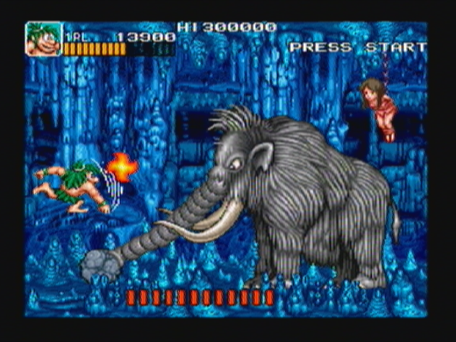 Joe & Mac: Caveman Ninja (Zeebo) screenshot: At the bottom of the pit lies a cave where the next boss, a mastodon, awaits.