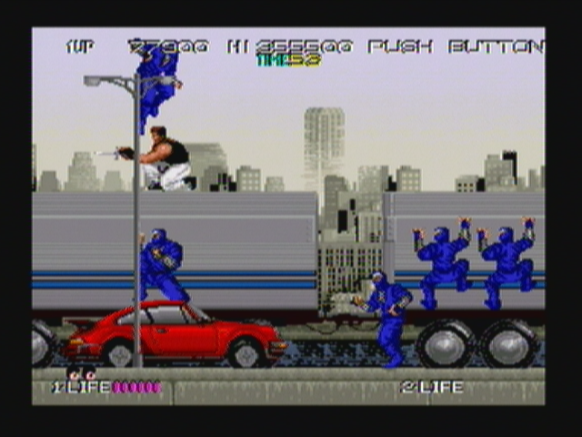 Bad Dudes (Zeebo) screenshot: Stage two starts with our hero on top of a truck. Ninjas will come from the sides of the truck, from the top of cars and even running in the street.