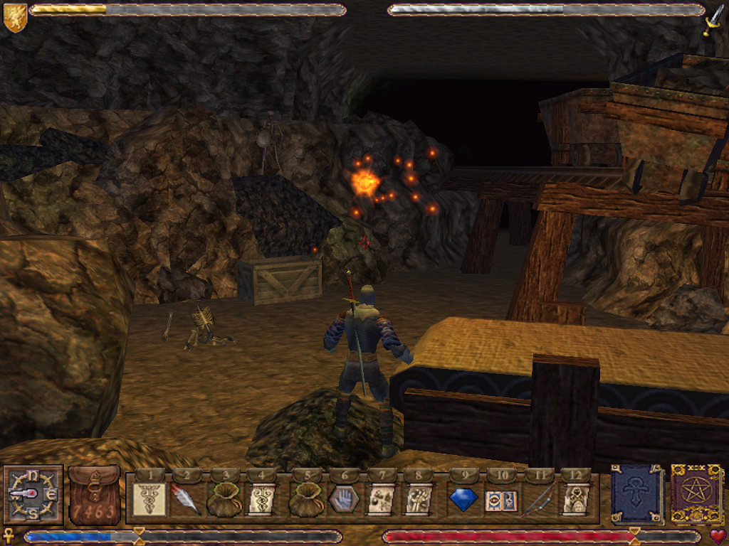 Ultima IX: Ascension (Windows) screenshot: Exploring abandoned mines. A skeleton warrior is ahead. Some bones lie on the ground - you have to hide them, or they'll come back to life... I cast Light to see better