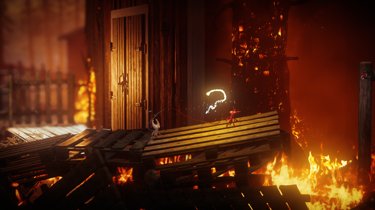 Unravel Two (Windows) screenshot: The fire has spread to houses