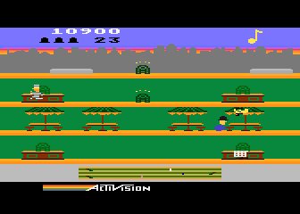 Keystone Kapers (Atari 8-bit) screenshot: Ducking a plane while Harry gets away!