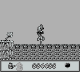 Chuck Rock (Game Boy) screenshot: Use the water spout to cross
