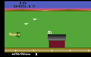 Barnstorming (Atari 2600) screenshot: Try to fly through the barns