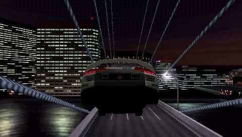 Ridge Racer (PSP) screenshot: The longest jump on Downton Rave City has you cross a huge gap in a bridge.