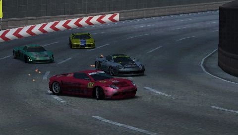 Ridge Racer (PSP) screenshot: Four cars drifting through a corner.