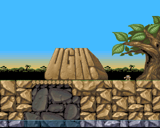 Ugh! (Amiga) screenshot: Our caveman is showing us the logo of the title