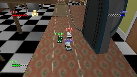 Micro Machines V4 (PSP) screenshot: Dueling with 2 cars near the smoothing-iron on Pedal Bin Pile-Up track