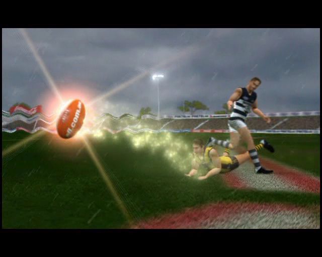 AFL Live 2004 (PlayStation 2) screenshot: When the game starts it shows an optional animated introduction, this comes before the title screen.<br> The glittering trail behind the ball is not present in the real game