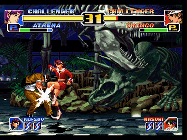 The King of Fighters '99: Millennium Battle (PlayStation) screenshot: Shingo's not feeling too good after a swift kick from Athena