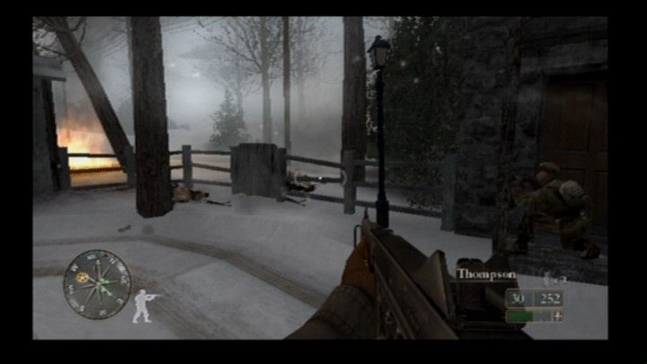 Call of Duty 2: Big Red One (PlayStation 2) screenshot: Enemy soldiers taking cover behind the fence