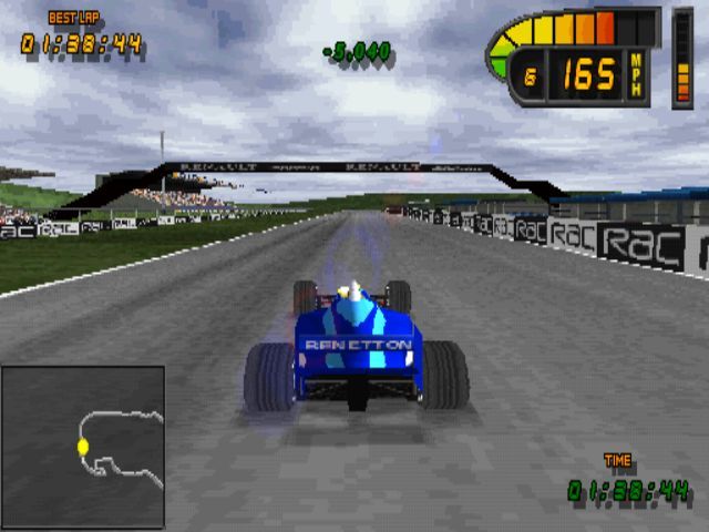 Formula 1 98 (PlayStation) screenshot: Performing a time trial at Silverstone<br>The green figures in the top/ centre of the screen show that the player has shaved 5 seconds of their previous best time