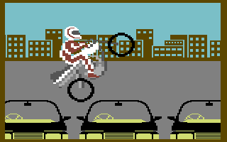 Eddie Kidd Jump Challenge (Commodore 64) screenshot: Jumping over cars
