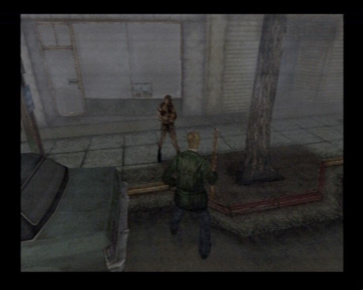 Silent Hill 2 (PlayStation 2) screenshot: Fighting a jacket monster on the street
