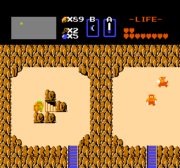 The Legend of Zelda (NES) screenshot: Moving a boulder and finding a hidden stairway.