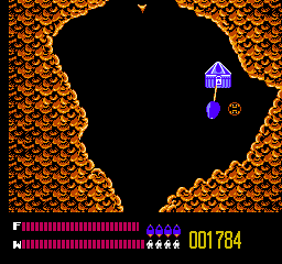 Solar Jetman: Hunt for the Golden Warpship (NES) screenshot: Pieces of the Golden Warpship itself are locked up in boxes such as these. You don't need a key, but you do need to throw it into the swirly hole and pick it up on the other side