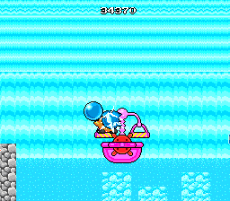 Liquid Kids (TurboGrafx-16) screenshot: Going across a waterfall in a boat with some scales on it