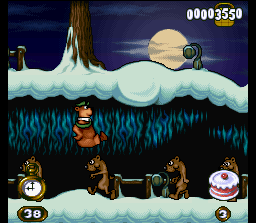 Adventures of Yogi Bear (SNES) screenshot: To escape from the danger, Yogi jumps above a row of weasels.