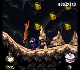 Adventures of Yogi Bear (SNES) screenshot: Yogi jumps to collect some baskets: a purple-skinned skunk is in your way...