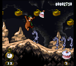 Adventures of Yogi Bear (SNES) screenshot: Yogi tries to jump above another row of weasels, but this time he's damaged!