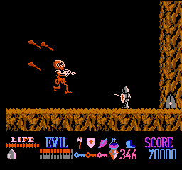 Wizards & Warriors (NES) screenshot: A jumping and bone-throwing skeleton-boss.