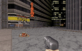Duke Nukem 3D (DOS) screenshot: The first few levels take place in recognizable urban environments. Here, Duke stands over an enemy corpse and figures out how to enter that building