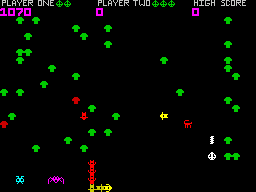 Spectipede (ZX Spectrum) screenshot: Here a Spectipede has hit a poisoned mushroom, turned red, fallen down the screen, and is working its way along the bottom towards me.