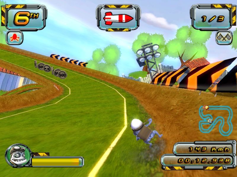 Crazy Frog Arcade Racer (Windows) screenshot: The first Championship Race in The Football Cup<br>This shows that we have a missile ready to fire, there are power up coins ahead on the track, and we're last
