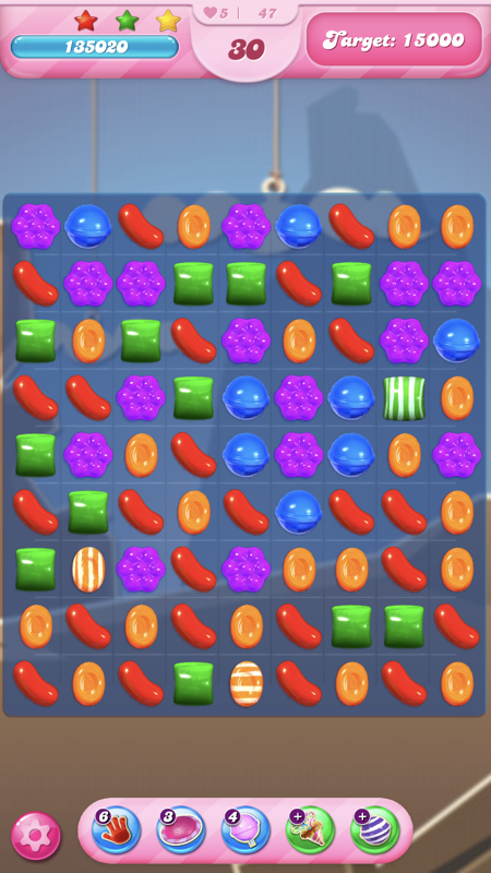 Candy Crush Saga (iPhone) screenshot: This is a moves level where you have to reach the target score in a limited number of moves.