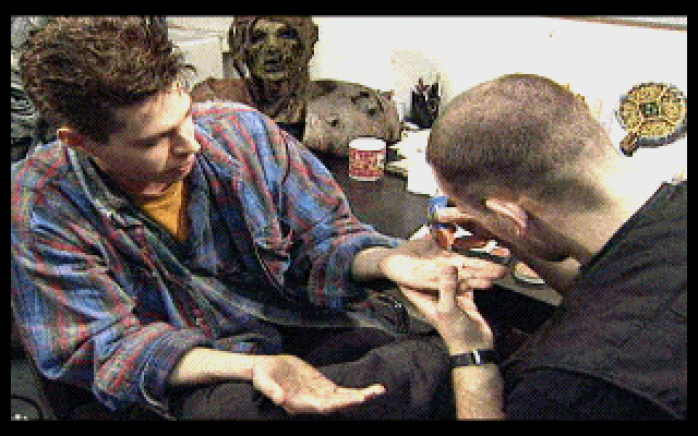 Realms of the Haunting (Limited Edition) (DOS) screenshot: David Tuomi in make-up with some masks on the table nearby