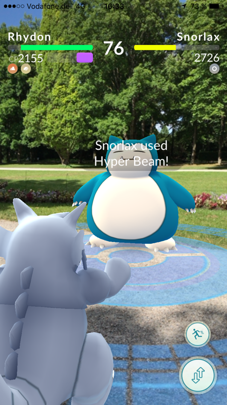 Pokémon GO (iPhone) screenshot: Gym battle with AR activated.