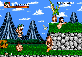 Joe & Mac: Caveman Ninja (Genesis) screenshot: Jumping and throwing a weapon at the same time