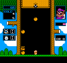 Wario's Woods (NES) screenshot: In "Round Game", Wario will occasionally pop up to increase the game's speed and lower the ceiling.