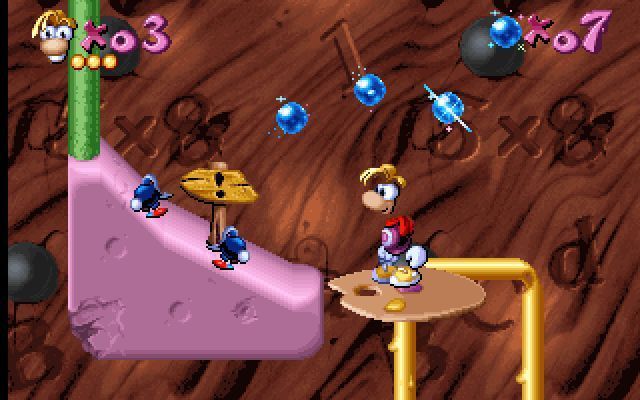 Maths and English with Rayman: Volume 3 (DOS) screenshot: The end of stage one, but the baddies must be cleared out of the way before jumping across.