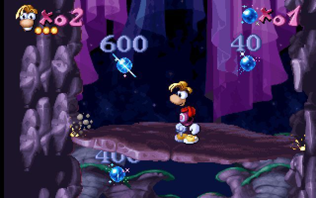 Maths and English with Rayman: Volume 3 (DOS) screenshot: Here Rayman must collect the blue berries beside the number spoken by the wizard. The number can be on either side. He must return to the centre of the rock after each number.