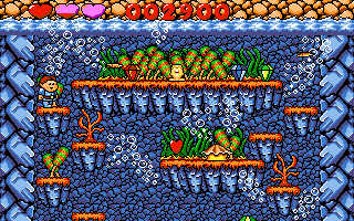 Dino Jnr. in Canyon Capers (DOS) screenshot: Golden statuette, gems and hearts should be collected (VGA)