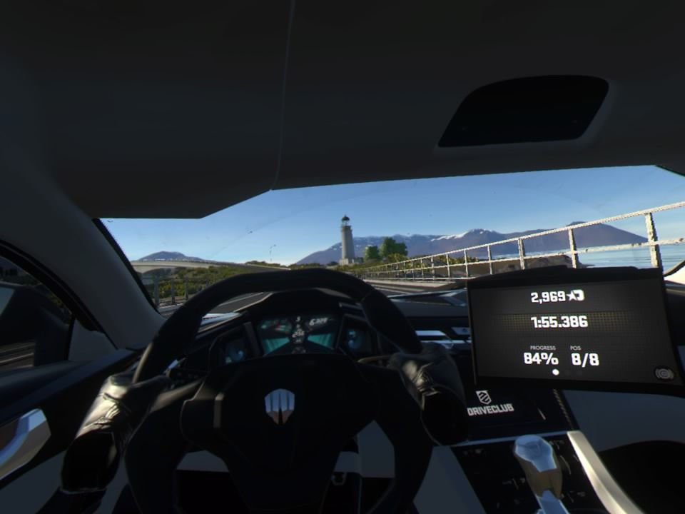 Driveclub VR (PlayStation 4) screenshot: Crossing the bridge toward the lighthouse in a Hyper