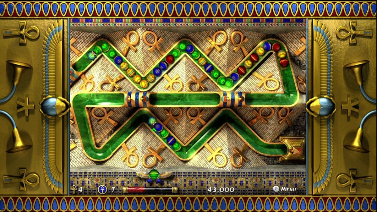 Luxor 2 (Xbox 360) screenshot: Shoot matching balls into the rolling columns to clear a sequence of colors.