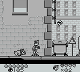 Spirou (Game Boy) screenshot: I'm not sure that dog just wants to play...