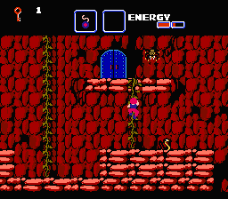 The Goonies II (NES) screenshot: Climbing on vines to reach a door