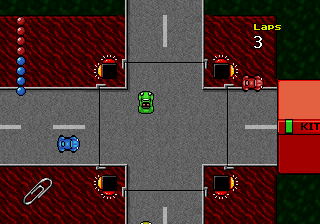 Micro Machines 2: Turbo Tournament (DOS) screenshot: ...and here is a "large" version of this kind of track, clearly assembled from pieces and with some educational value ("pay attention to traffic lights!").