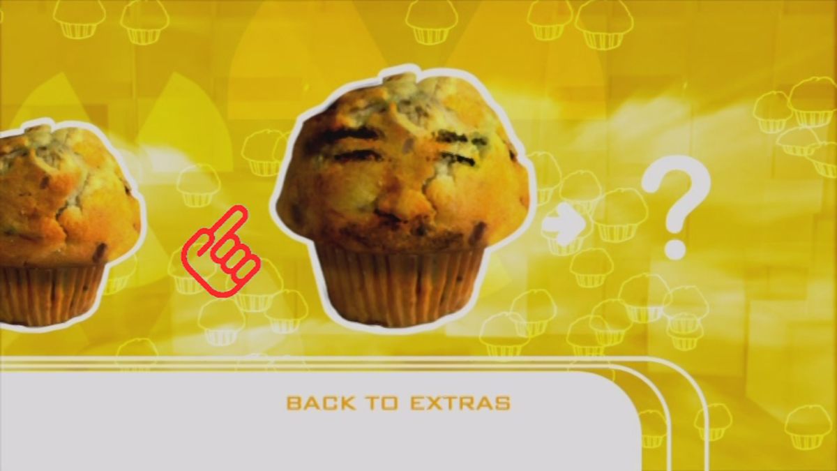 Ross Noble: Sonic Waffle (DVD Player) screenshot: Here it is, a face on a muffin.<br>When the DVD remote button is pressed the face is revealed - but NOT the name - and the next muffin is shown