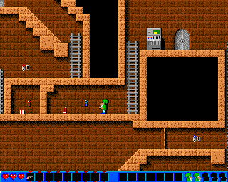 Permonie (Amiga) screenshot: Level 1 - Player is heading for Dynamite that is next to a destroyable wall. There is a Med Kit and Key behind the Wall.
