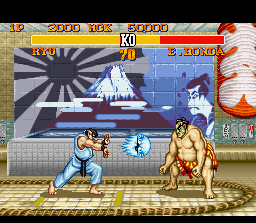 Street Fighter II Turbo (SNES) screenshot: Ryu throws a Hadouken in direction to Honda, but what will do the Sumo fighter: jump or defend?