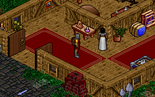 Pagan: Ultima VIII (DOS) screenshot: Exploring somebody's house. Try talking to this lady. Most of the inhabitants of Pagan are scared of everything...